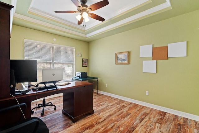 office area with hardwood / wood-style flooring, ceiling fan, crown molding, and a raised ceiling