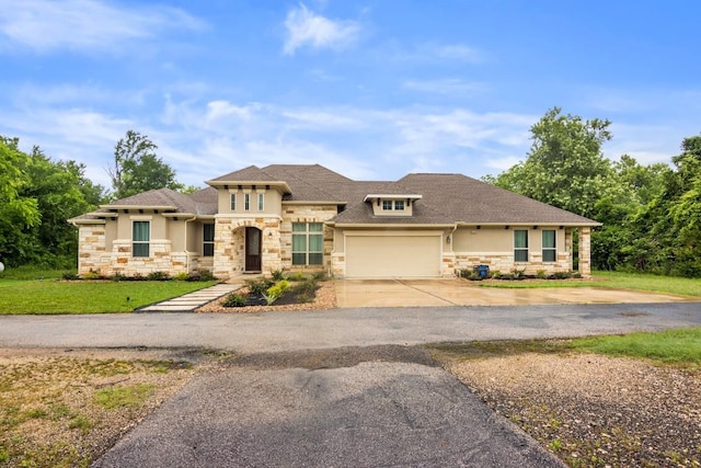 view of front of home featuring a garage and a front lawn