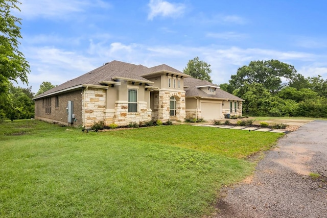 view of front of house featuring a garage and a front lawn