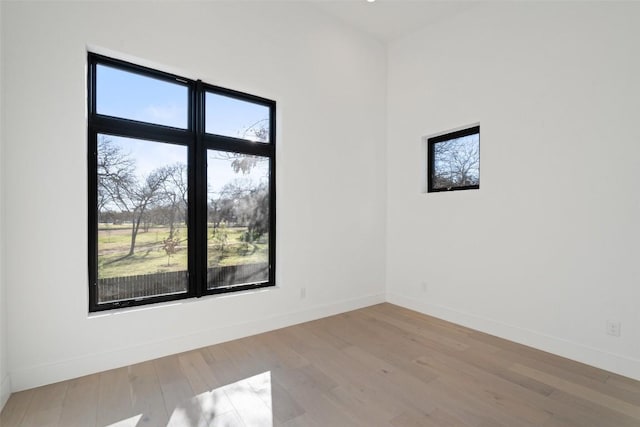 empty room featuring plenty of natural light and light hardwood / wood-style floors