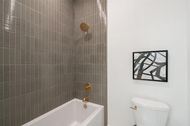 bathroom featuring toilet and tiled shower / bath combo