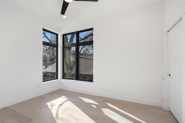 unfurnished room with ceiling fan and light wood-type flooring