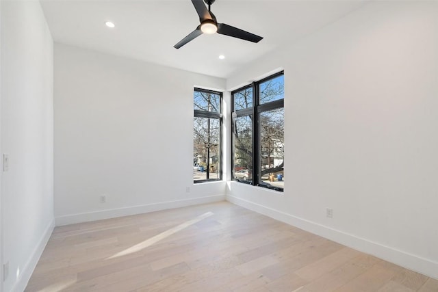 spare room with light hardwood / wood-style flooring and ceiling fan