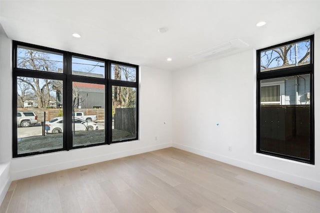 empty room with light hardwood / wood-style flooring