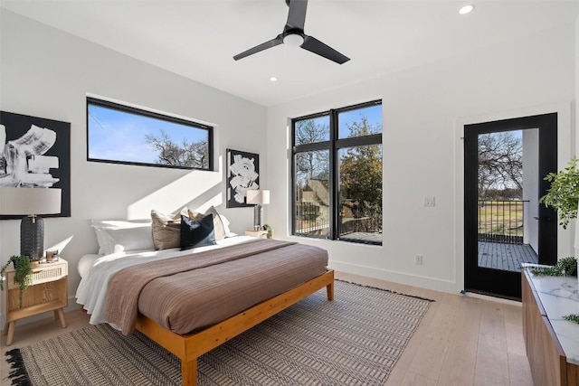 bedroom featuring access to exterior, light hardwood / wood-style flooring, and ceiling fan