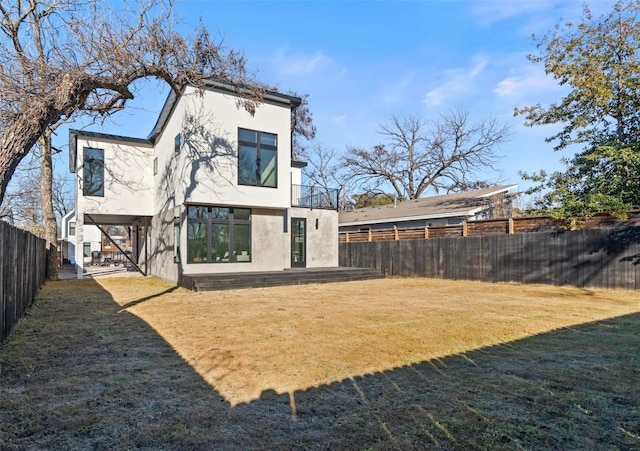 back of house featuring a lawn