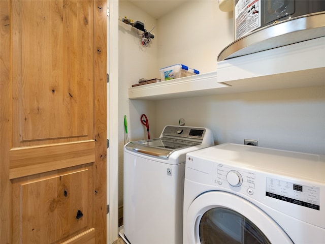 clothes washing area featuring washer and dryer