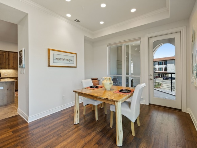 dining space featuring crown molding and dark hardwood / wood-style floors