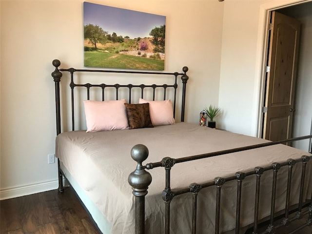 bedroom with dark wood-type flooring