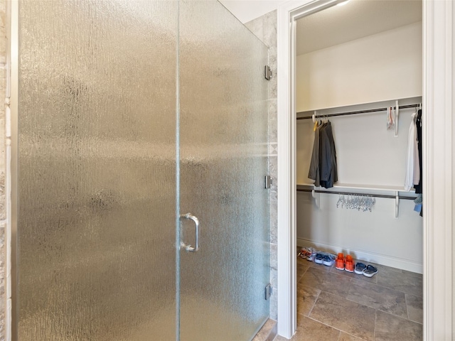 bathroom featuring a shower with door