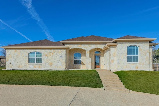 mediterranean / spanish house with a front lawn