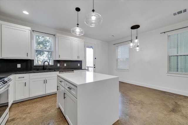 kitchen with sink, hanging light fixtures, backsplash, white cabinets, and white range