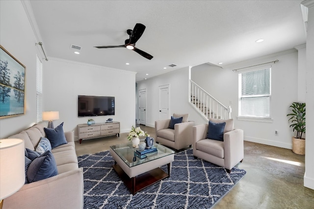 living room with ceiling fan and ornamental molding