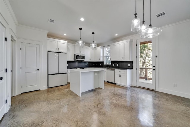 kitchen with white fridge, a center island, pendant lighting, and dishwashing machine