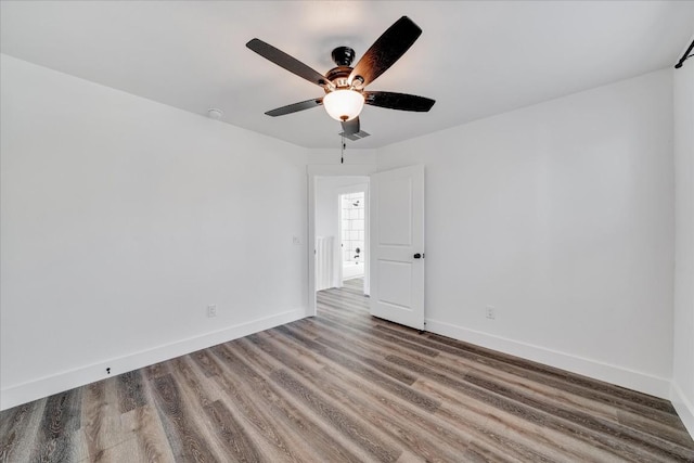 unfurnished room with hardwood / wood-style floors and ceiling fan