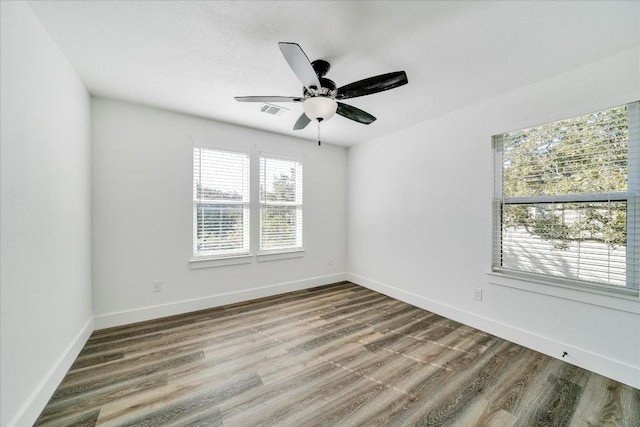 empty room with hardwood / wood-style flooring and ceiling fan