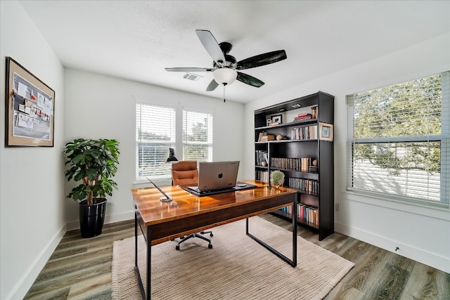 office area featuring dark wood-type flooring and ceiling fan