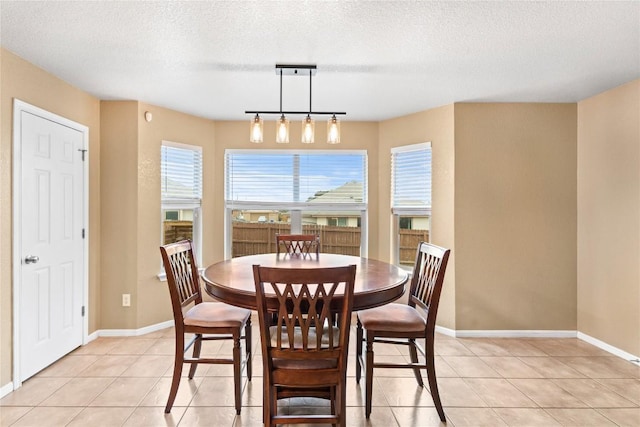 dining room with light tile patterned floors and a textured ceiling