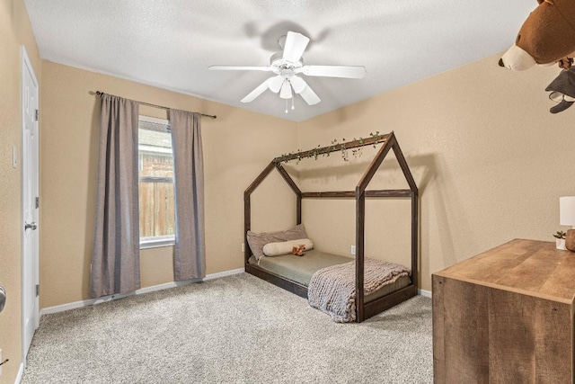 unfurnished bedroom with light carpet, a textured ceiling, and ceiling fan