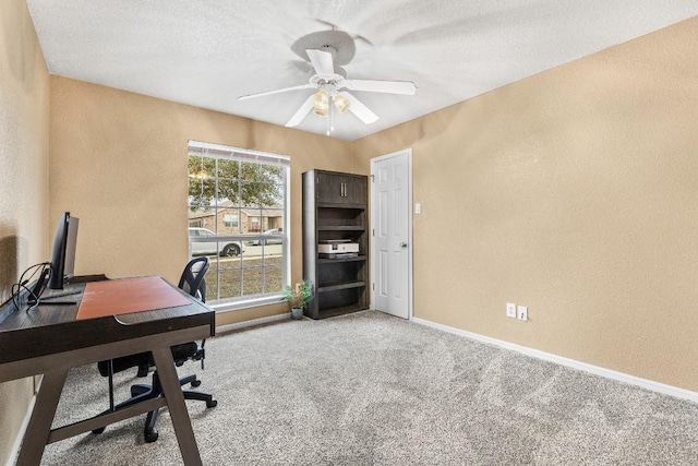 home office with ceiling fan, light colored carpet, and a textured ceiling