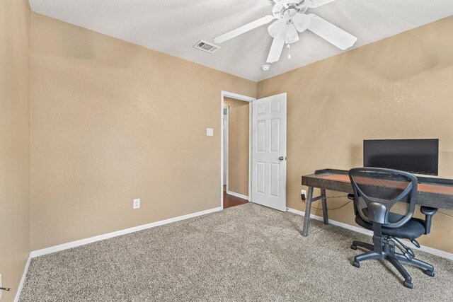 carpeted office featuring ceiling fan