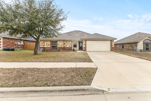 view of front facade featuring a garage and a front lawn