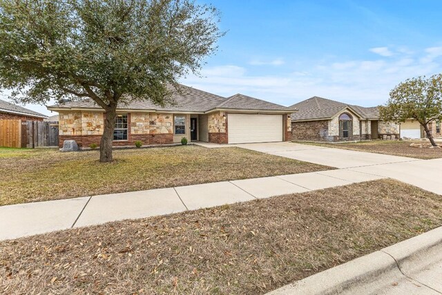 ranch-style home featuring a garage and a front yard