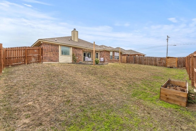 back of house featuring a yard