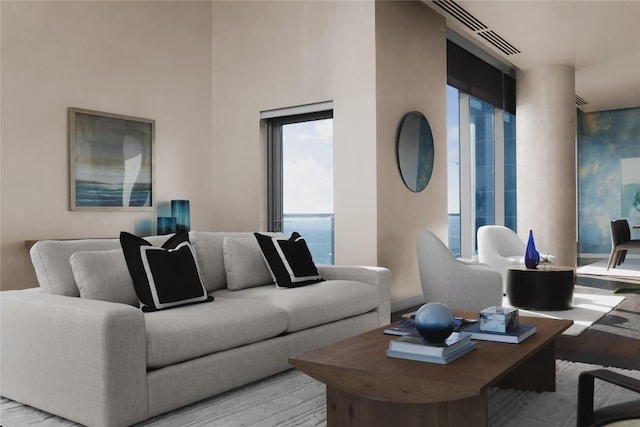 living room featuring a water view and light hardwood / wood-style flooring