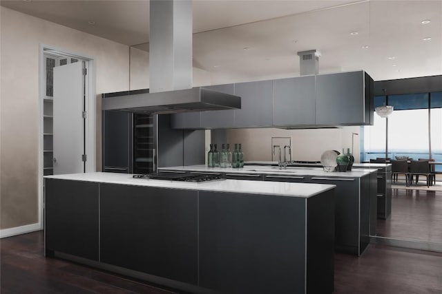 kitchen with a kitchen island, island range hood, sink, black gas stovetop, and dark wood-type flooring