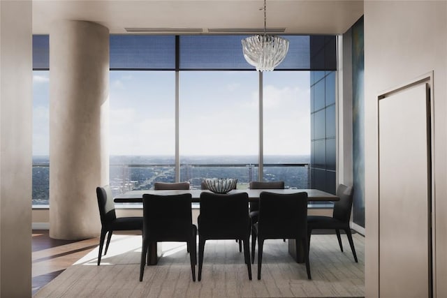 dining room with an inviting chandelier, plenty of natural light, expansive windows, and hardwood / wood-style flooring