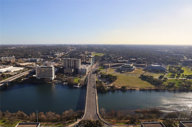 aerial view at dusk featuring a water view