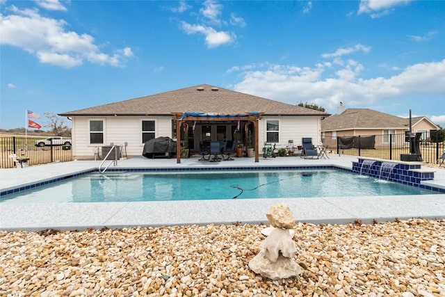 view of swimming pool featuring a patio, pool water feature, and grilling area