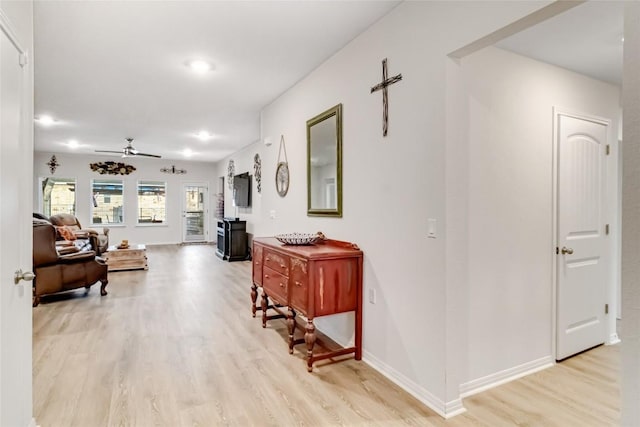 corridor with light hardwood / wood-style flooring