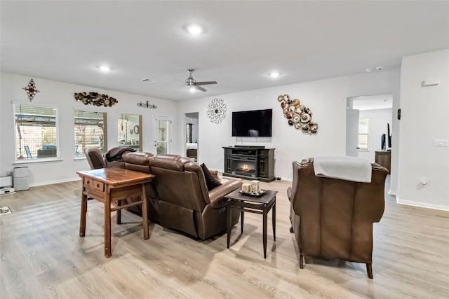 living room with ceiling fan and light wood-type flooring