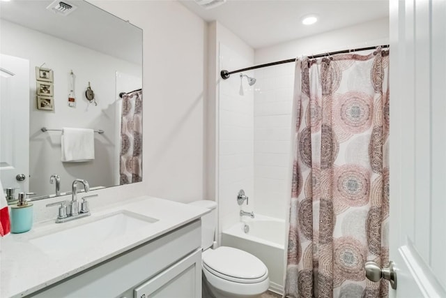 full bathroom with vanity, shower / bath combo, and toilet