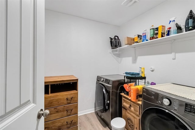 washroom featuring independent washer and dryer and light wood-type flooring