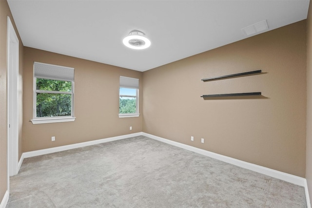 unfurnished room with light carpet