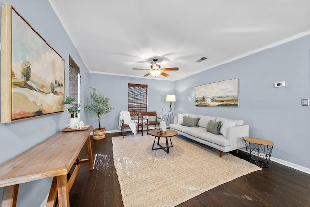 living room featuring dark hardwood / wood-style flooring, ornamental molding, and ceiling fan