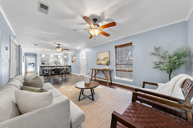 living room with crown molding and wood-type flooring