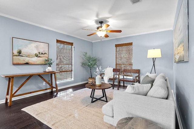 living room with dark hardwood / wood-style flooring, crown molding, and ceiling fan