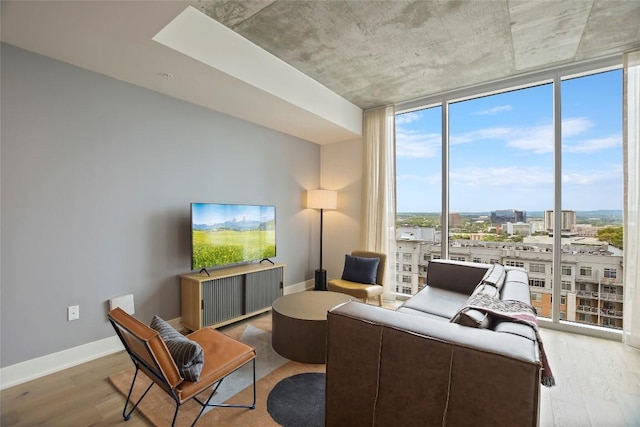 living room with floor to ceiling windows and light hardwood / wood-style floors