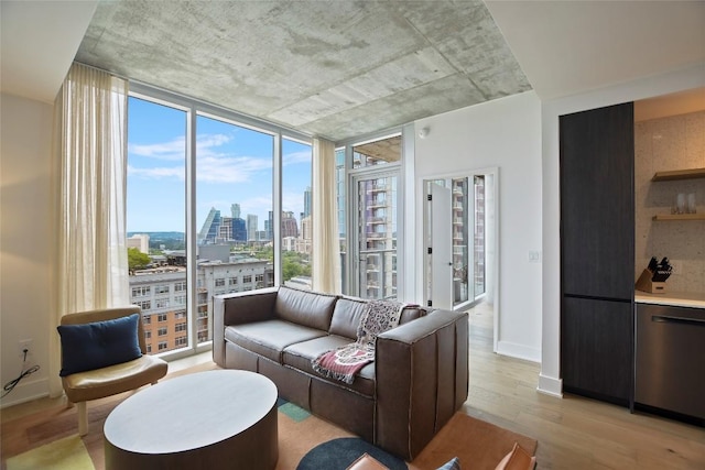 living room featuring light wood-type flooring and a wall of windows