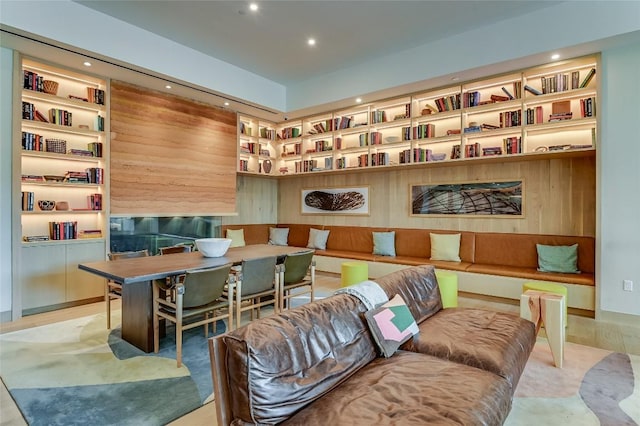 sitting room with built in features and light hardwood / wood-style floors