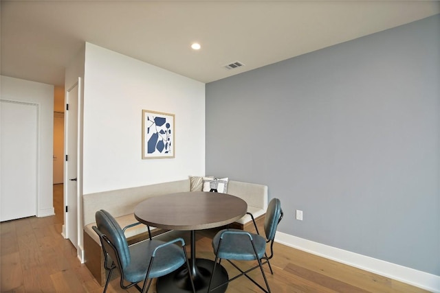 dining space featuring wood-type flooring