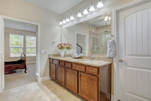 bathroom with walk in shower, ceiling fan, vanity, and tile patterned flooring