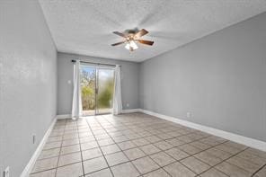 unfurnished room featuring light tile patterned floors, a textured ceiling, and ceiling fan