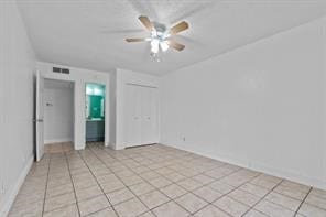 spare room with light tile patterned floors and ceiling fan