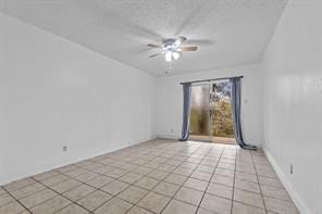 tiled empty room with ceiling fan