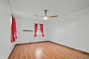 empty room featuring hardwood / wood-style flooring and ceiling fan